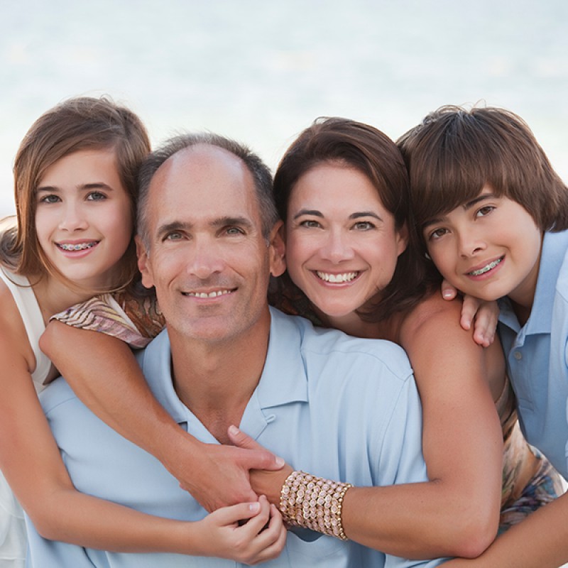 Picture of a family with two kids wearing braces
